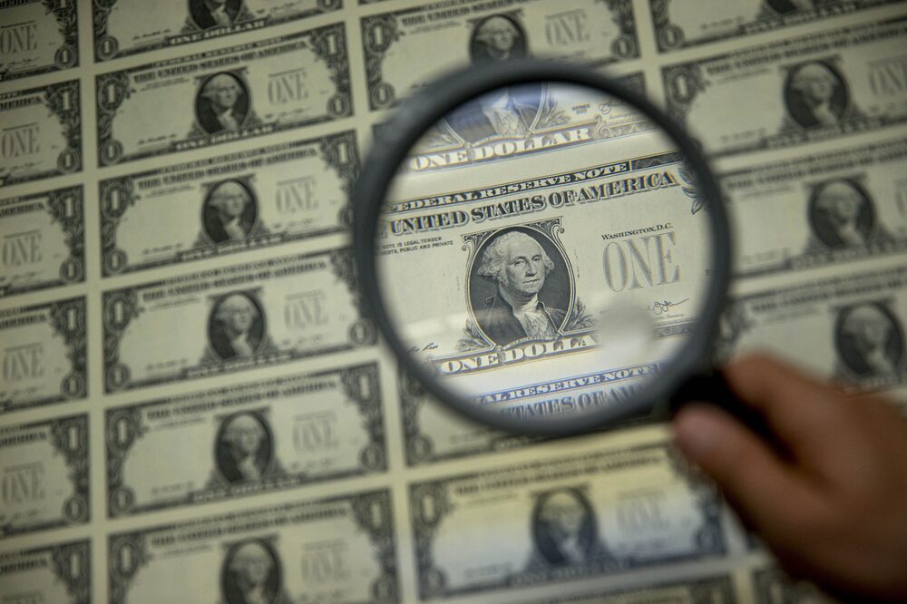 A magnifying glass is held over a 50 subject one dollar note sheet after being printed by an intaglio printing press in this arranged photograph at the U.S. Bureau of Engraving and Printing in Washington, D.C., U.S., on Tuesday, April 14, 2015. Republican efforts to pass a fiscal year 2016 budget cleared another hurdle as the House named its members to a conference committee and Senate Majority Leader Mitch McConnell pledged to do the same by the end of the week. Photographer: Andrew Harrer/Bloomberg A magnifying glass is held over a 50 subject one dollar note sheet after being printed by an intaglio printing press in this arranged photograph at the U.S. Bureau of Engraving and Printing in Washington, D.C., U.S., on Tuesday, April 14, 2015. Republican efforts to pass a fiscal year 2016 budget cleared another hurdle as the House named its members to a conference committee and Senate Majority Leader Mitch McConnell pledged to do the same by the end of the week. Photographer: Andrew Harrer/Bloomberg